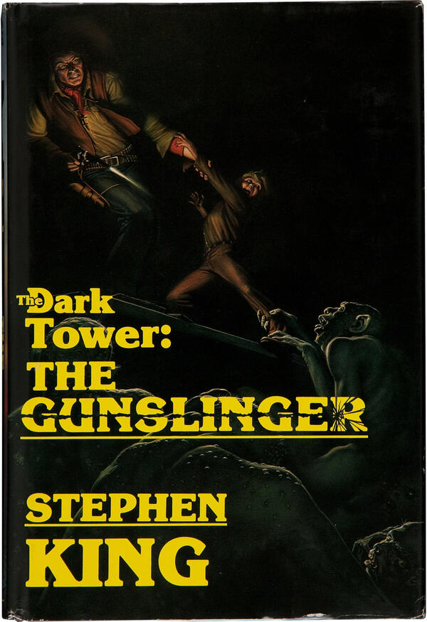 A book cover for "The Dark Tower: The Gunslinger" by Stephen King. The illustrated cover is of a cowboy and a young boy trying to escape humanoid creatures in a dimly lit space.