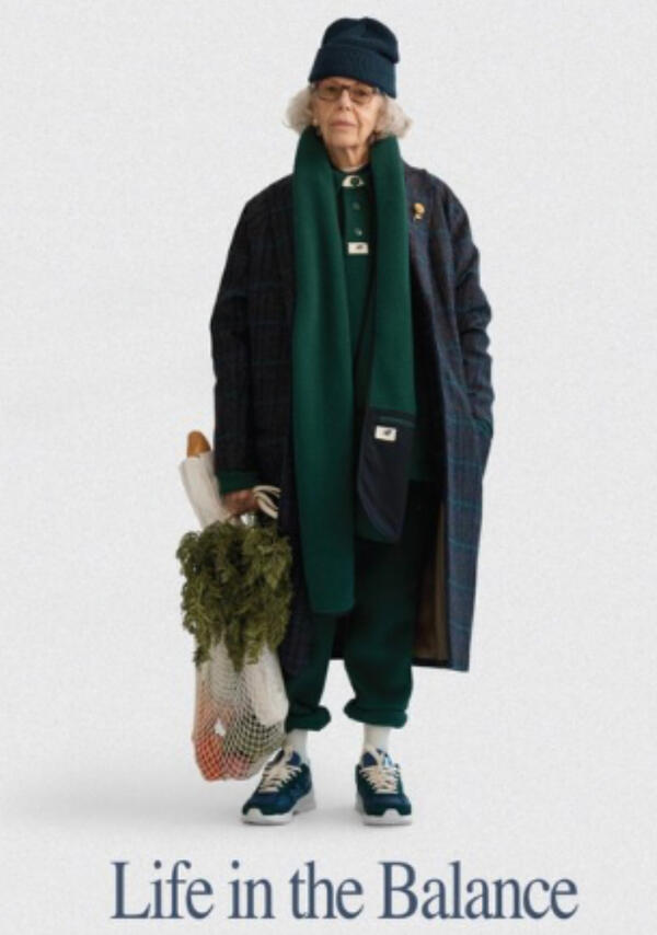 A New Balance magazine advertisement featuring an older woman dressed in a juxtaposing cool, winter streetwear style. The tagline reads "Life in the Balance".